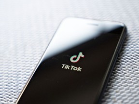 Signage for ByteDance Ltd.'s TikTok app is displayed on a smartphone in an arranged photograph taken in Arlington, Virginia, U.S., on Monday, Aug. 3, 2020. In a bid to salvage a deal for the U.S. operations of TikTok, Microsoft Corp. Chief Executive Officer Satya Nadella spoke with President Donald Trump by phone about how to secure the administrations blessing to buy the wildly popular, but besieged, music video app.