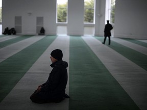 In this March 3, 2023 file photo, members of the Ahmadiyya Muslim Community pray inside the Baitul Futuh Mosque in Morden, south west London.