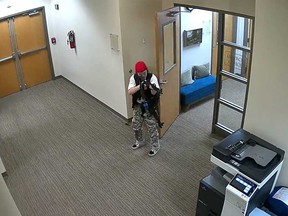A still image from surveillance video shows what the Metropolitan Nashville Police Department describe as mass shooting suspect Audrey Elizabeth Hale, 28, entering The Covenant School carrying weapons in Nashville, Tenn., March 27, 2023