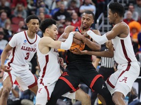 Micah Parrish of the San Diego State Aztecs battles for the ball against Jahvon Quinerly and Brandon Miller of the Alabama Crimson Tide at KFC YUM! Center on March 24, 2023 in Louisville, Kentucky.