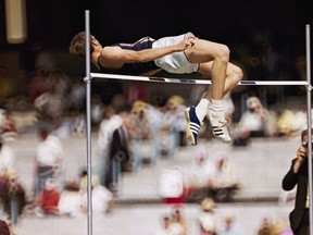 Dick Fosbury, of the United States, clears the bar in the high jump competition at the 1968 Mexico City Olympics.