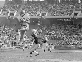 Kansas City Chiefs' Otis Taylor catches a first quarter pass from quarterback Len Dawson (not shown) for 12 yards and a first down as Oakland Raiders Nemiah Wilson defends, during the AFL championship game in Oakland, Calif., Jan. 4, 1970.