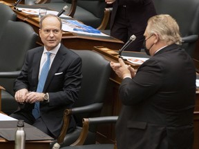 Ontario Finance Minister Peter Bethlenfalvy is applauded by Premier Doug Ford after delivering the Provincial Budget in the Ontario Legislature in Toronto on Wednesday, March 24, 2021.