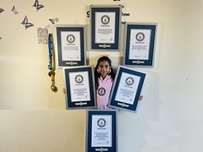 Mamathi Vinoth, 9, is shown with her Guinness world records in an undated handout photo. Vinoth practised hula hooping almost every day after school until bedtime before she spun and hopped her way through three Guinness World Records.