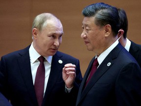 Russian President Vladimir Putin speaks with Chinese President Xi Jinping before an extended-format meeting of heads of the Shanghai Cooperation Organization summit (SCO) member states in Samarkand, Uzbekistan Sept. 16, 2022.