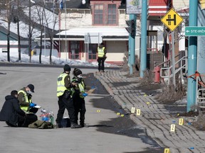 Police officers investigate the scene in Amqui, Que., Tuesday, March 14, 2023.