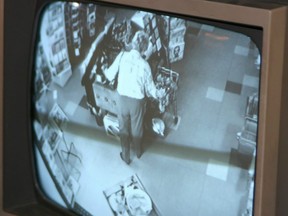 A store security monitor shows a shoplifter caught in the act.