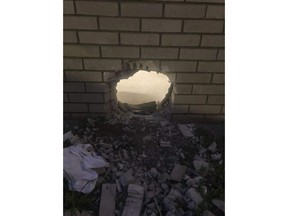 This photo provided by Newport News Sheriff's Office shows a hole in the wall of a prison cell in Newport News, Va., on March 20, 2023.