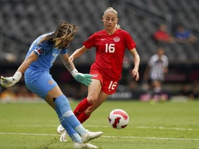 Canada's Janine Beckie (16) pressures Costa Rica's goalkeeper, Daniela Solera, during a CONCACAF Women's Championship soccer match in Monterrey, Mexico, Monday, July 11, 2022.