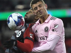 Mar 18, 2023; Toronto, Ontario, CAN;   Toronto FC forward Ayo Akinola (20, left) battles for the ball with Inter Miami defender Christopher McVey(4) in the second half at BMO Field.