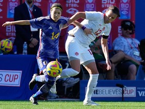 Japan midfielder Yui Hasegawa (14) and Canada midfielder Christine Sinclair (12) fight for possession of the ball during the first half at Toyota Stadium on Feb 22, 2023, in Frisco, Texas