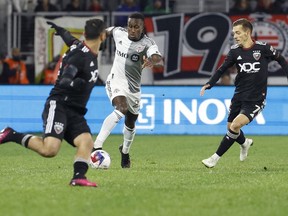 Feb 25, 2023; Washington, District of Columbia, USA; Toronto FC defender Richie Laryea dribbles the ball as D.C. United defender Pedro Santos chases in the first half at Audi Field.