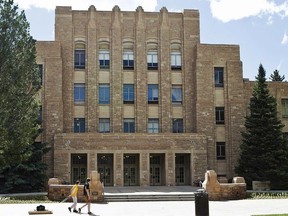 In this June 14, 2016, file photo, two people walk on the University of Wyoming campus in Laramie, Wyo.