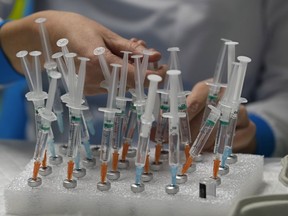 A nurse prepares vaccines in the Wizink Center, used for COVID-19 vaccinations, in Madrid, Dec. 1, 2021.