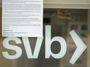 A note is written on a glass door of a Silicon Valley Bank branch location in Pasadena, Calif., March 27, 2023.