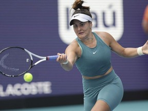Bianca Andreescu, of Canada, returns a volley from Emma Raducanu, of Great Britain, in the first set of a match at the Miami Open tennis tournament, Wednesday, March 22, 2023, in Miami Gardens, Fla.