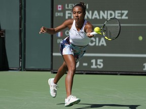 Leylah Fernandez, of Canada, returns to Caroline Garcia, of France, at the BNP Paribas Open tennis tournament in Indian Wells, Calif., Monday, March 13, 2023. Fernandez and American partner Taylor Townsend advanced to the Miami Open women's doubles semifinals Tuesday, with a 2-6, 6-6 (4), 10-8 win over Jelena Ostapenko of Latvia and Lyudmyla Kichenok of Ukraine.