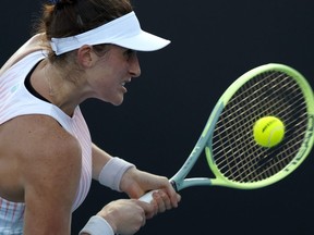 Rebecca Marino of Canada plays a backhand return to Zhu Lin of China during their first round match at the Australian Open tennis championship in Melbourne, Australia, Jan. 16, 2023.
