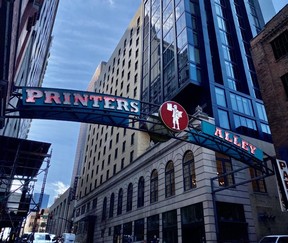 The Printers Alley sign with Noelle as a backdrop. CYNTHIA MCLEOD/TORONTO SUN