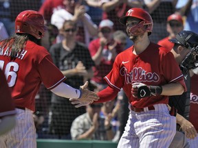 Philadelphia Phillies’ Trea Turner shakes hands with Brandon Marsh (16) after Turner hit a two-run home run off Detroit Tigers’ Joey Wentz during the fifth inning of a spring training baseball game Thursday, March 23, 2023, in Clearwater, Fla.