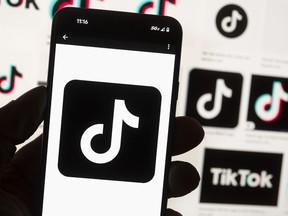 The TikTok logo is seen on a cellphone on Oct. 14, 2022, in Boston. TikTok says every account held by a user under the age of 18 will automatically be set to a 60-minute daily screen time limit in the coming weeks amid growing concerns about the app's security.