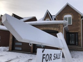A house for sale sign is shown in front of a house in Oakville on Sunday, Feb.5, 2023.