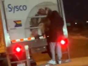 Police are looking for a man last seen hanging on to the back of a transport truck which was travelling along on the QEW.