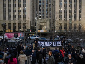 Anti-Trump demonstrators protest outside the Manhattan District Attorney's office in New York on March 21, 2023.