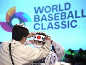 One of Japan fan prepares to cheer their them before they watch on a live stream of a World Baseball Classic (WBC) final between Japan and United States being played at LoanDepot Park in Miami, during a public viewing event Wednesday, March 22, 2023, in Tokyo.