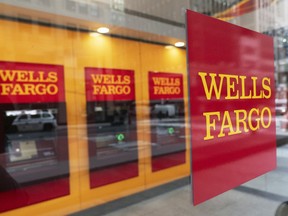 A Wells Fargo bank sign is affixed to a window on Jan. 13, 2021, in New York.
