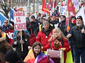 Members of the Public Service Alliance of Canada (PSAC) demonstrate outside the Treasury Board building in Ottawa on Friday, March 31, 2023.
