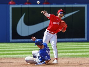 Santiago Espinal of the Toronto Blue Jays throws to first as Michael Massey of the Kansas City Royals is tagged out at second in the third inning their MLB game at Rogers Centre on July 16, 2022 in Toronto, Canada. (Cole Burston/Getty Images)