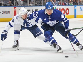 William Nylander of the Toronto Maple Leafs skates around Mikhail Sergachev of the Tampa Bay Lightning during the second period of an NHL game at Scotiabank Arena on December 20, 2022 in Toronto, Ontario, Canada.