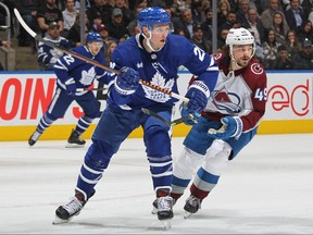 Samuel Girard of the Colorado Avalanche (right) skates against Maple Leafs' Sam Lafferty during a game on March 15, 2023.