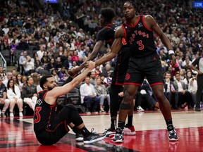 Fred VanVleet #23 of the Toronto Raptors is helped up by team-mates Chris Boucher #25 and O.G. Anunoby #3 during the 2023 Play-In Tournament against the Chicago Bulls at the Scotiabank Arena on April 12, 2023 in Toronto.