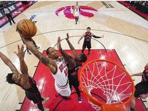 DeMar DeRozan of the Chicago Bulls goes to the basket against Scottie Barnes and Pascal Siakam of the Toronto Raptors during the 2023 Play-In Tournament at the Scotiabank Arena on April 12, 2023 in Toronto, Ontario, Canada.