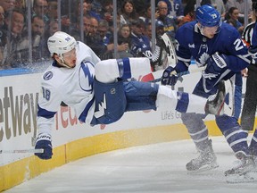 Mikhail Sergachev of the Tampa Bay Lightning is taken into the boards by Sam Lafferty of the Toronto Maple Leafs during Game One of the First Round of the 2023 Stanley Cup Playoffs at Scotiabank Arena on April 18, 2023 in Toronto, Ontario, Canada.