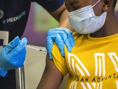 Tse Cowan, 8, winces as he is administered the coronavirus (COVID-19) vaccine at a vaccination pop-up site at P.S. 19 on Nov. 8, 2021 in the Lower East Side in New York City.