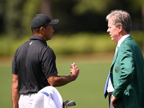 Tiger Woods of the United States greets Fred Ridley, Chairman of Augusta National Golf Club, in the practice area prior to the 2023 Masters Tournament at Augusta National Golf Club on April 2, 2023 in Augusta, Ga.
