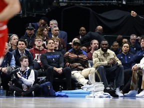 (L to R) Dallas Mavericks owner Mark Cuban,  Kyrie Irving and Tim Hardaway Jr. sit court side during the game against the Chicago Bulls at American Airlines Center on April 07, 2023 in Dallas, Texas.