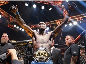 Israel Adesanya of Nigeria celebrates after knocking uot Alex Pereira of Brazil during their Middleweight fight at Kaseya Center on April 08, 2023 in Miami, Florida.
