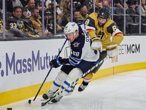 Nate Schmidt of the Winnipeg Jets skates with the puck against Phil Kessel of the Vegas Golden Knights in the second period of Game One of the First Round of the 2023 Stanley Cup Playoffs at T-Mobile Arena on April 18, 2023 in Las Vegas, Nevada. The Jets defeated the Golden Knights 5-1.