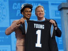 Bryce Young poses with NFL commissioner Roger Goodell after being selected first overall by the Carolina Panthers during the first round of the 2023 NFL Draft.