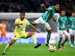 America's Jonathan Dos Santos (left) and Leon's Lucas Romero (right) vie for the ball during their Mexican Clausura 2023 tournament football match at the Azteca stadium in Mexico City on April 1, 2023.