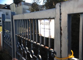 A sign reads 'Police, entrance is forbidden' in the back entrance of the house of Josef Fritzl, an Austrian father who imprisoned and raped his daughter in a cellar for 24 years, in Amstetten on March 4, 2009.