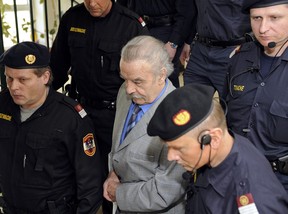 Josef Fritzl (C) leaves the courthouse escorted by guards after the proclamation of his sentence during the fourth day of his trial for incest on March 19, 2009, at the provincial courthouse in St. Poelten.