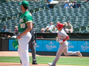 Cincinnati Reds catcher Luke Maile (22) rounds the bases after hitting a home run off of Oakland Athletics starting pitcher Kyle Muller (39) during the third inning at RingCentral Coliseum.