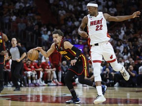 Atlanta Hawks guard Trae Young (11) dribbles the ball past Miami Heat forward Jimmy Butler (22) during the first quarter at Kaseya Center April 11, 2023. Sam Navarro-USA TODAY Sports