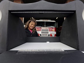 In this file photo taken on Thursday, Feb. 26, 2015, Monica Kelsey, firefighter and medic who is president of Safe Haven Baby Boxes Inc., poses with a prototype of a baby box.