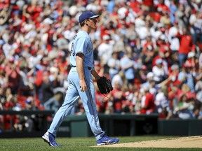 Blue Jays starting pitcher Chris Bassitt walks back to the mound after giving up a two-run home run during the first inning against the St. Louis Cardinals, Sunday, April 2, 2023, in St. Louis.